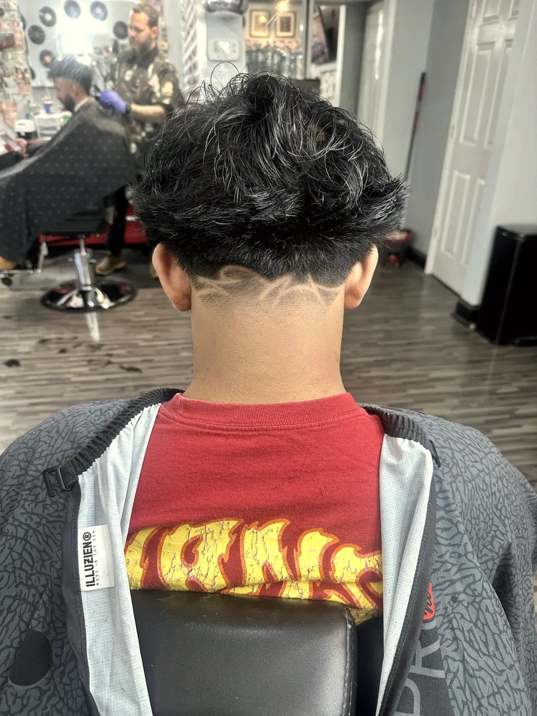 Low taper with a freehand design on the back of the neck