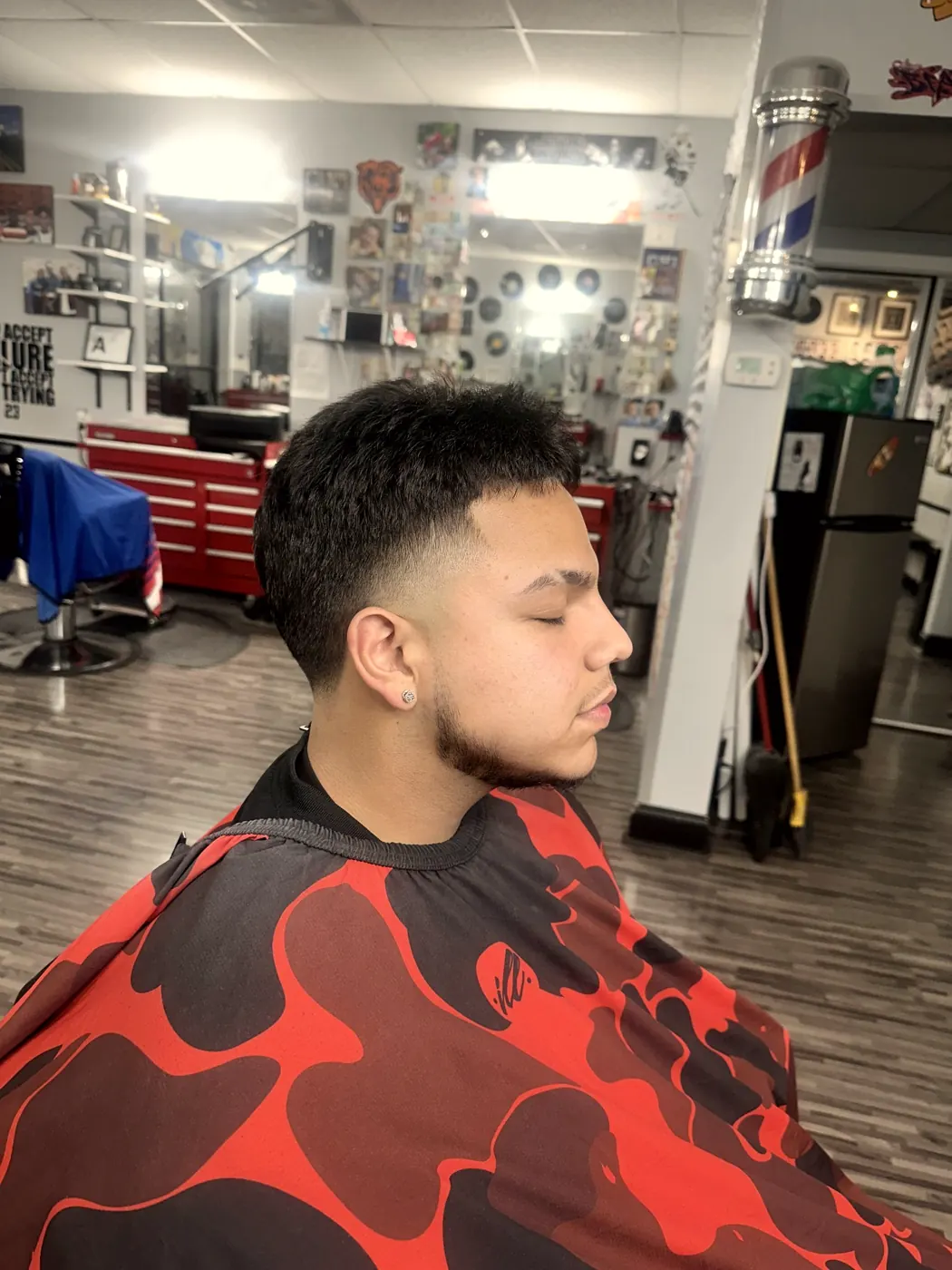 Record wall, barber pole and a fresh cut in the chair