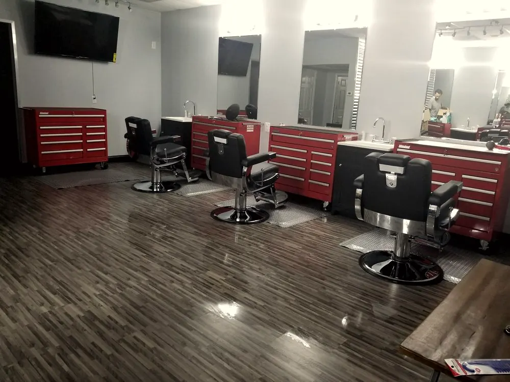 Red toolbox stations and black barber chairs